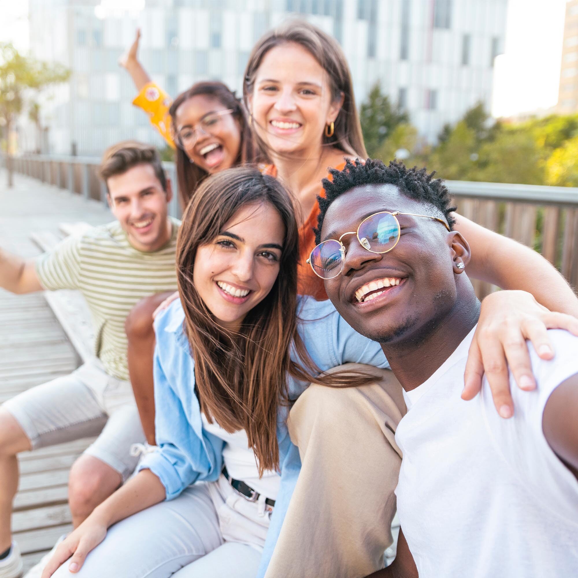 happy Multiracial group of friends making a selfie with phone in the university, focus on the girl - friendship, happiness and joyful concept. High quality photo