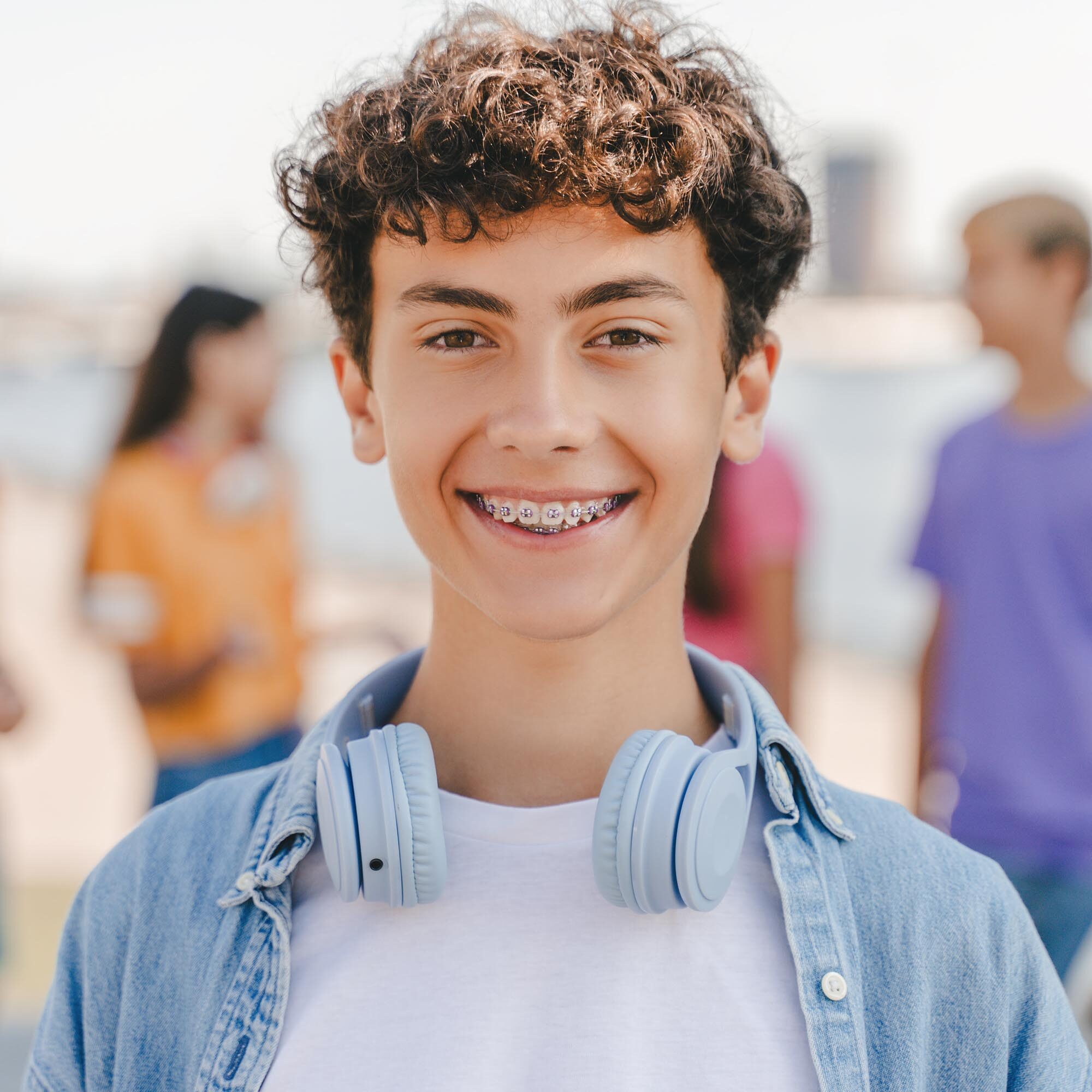 Authentic portrait of smiling teenage boy with braces wearing he